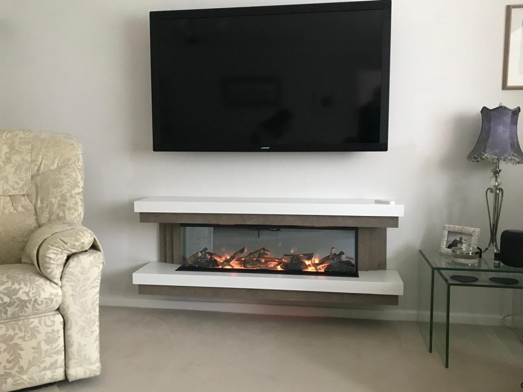 Wall-mounted electric fire suite beneath a TV, installed by Fire Flair Direct
