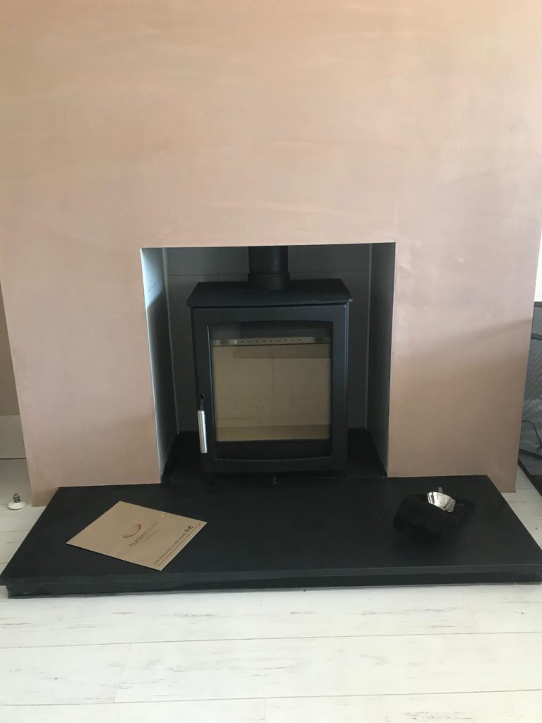 Wood-burning stove on a black slate hearth, installed by Fire Flair Direct