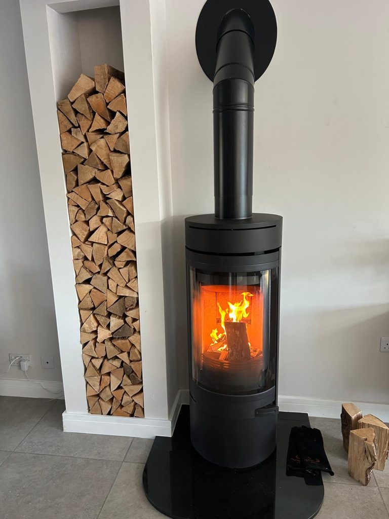 Contemporary freestanding wood-burning stove with log store, installed by Fire Flair Direct